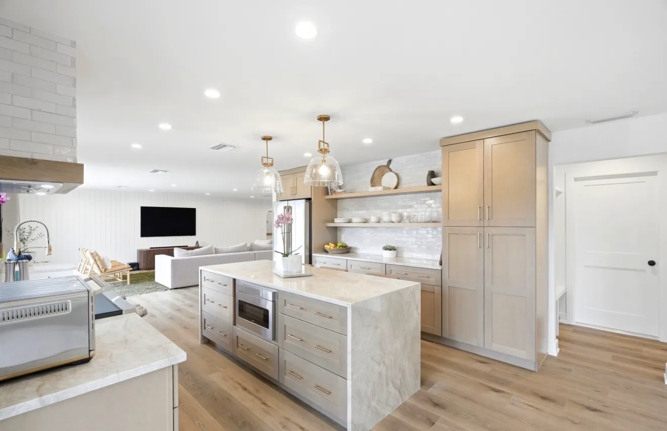 White oak kitchen island with brass pendant lights