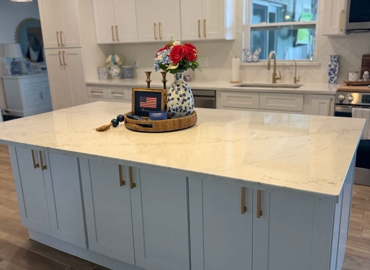 Pale blue island with a marble counter and brass pulls