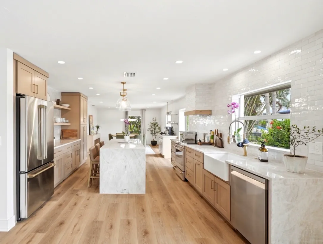 The same white oak kitchen along the wood floor toward the far end