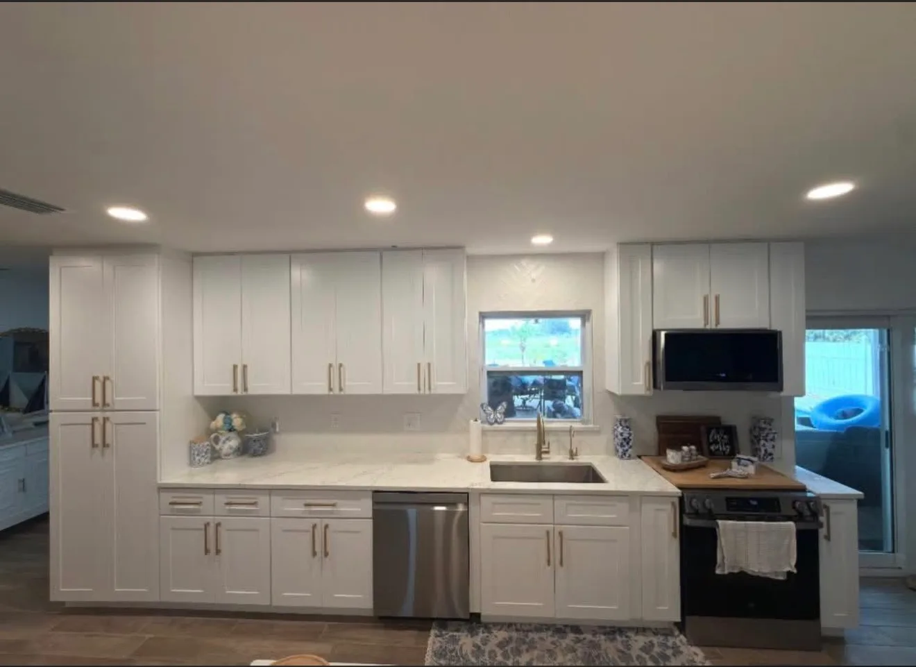 White shaker kitchen with brass hardware and a wide kitchen island