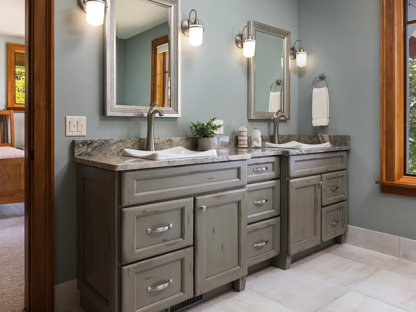 Bathroom cabinetry with drawer storage beneath a stone counter