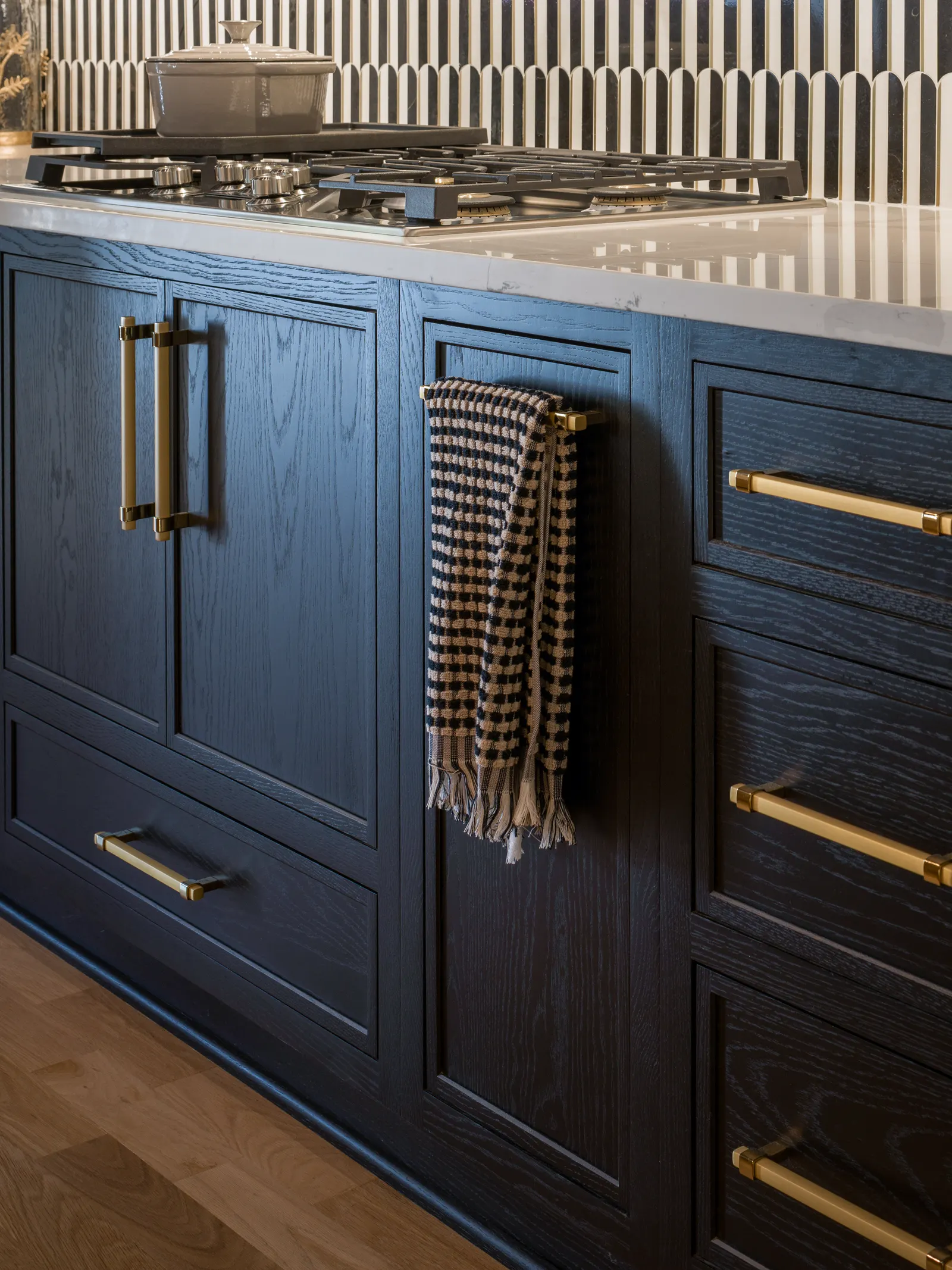Navy drawer fronts with brass hardware, close in